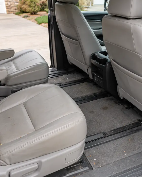 Illustration: second row of a family minivan with crumbs on the seat and dirt in the carpet, before the Reset